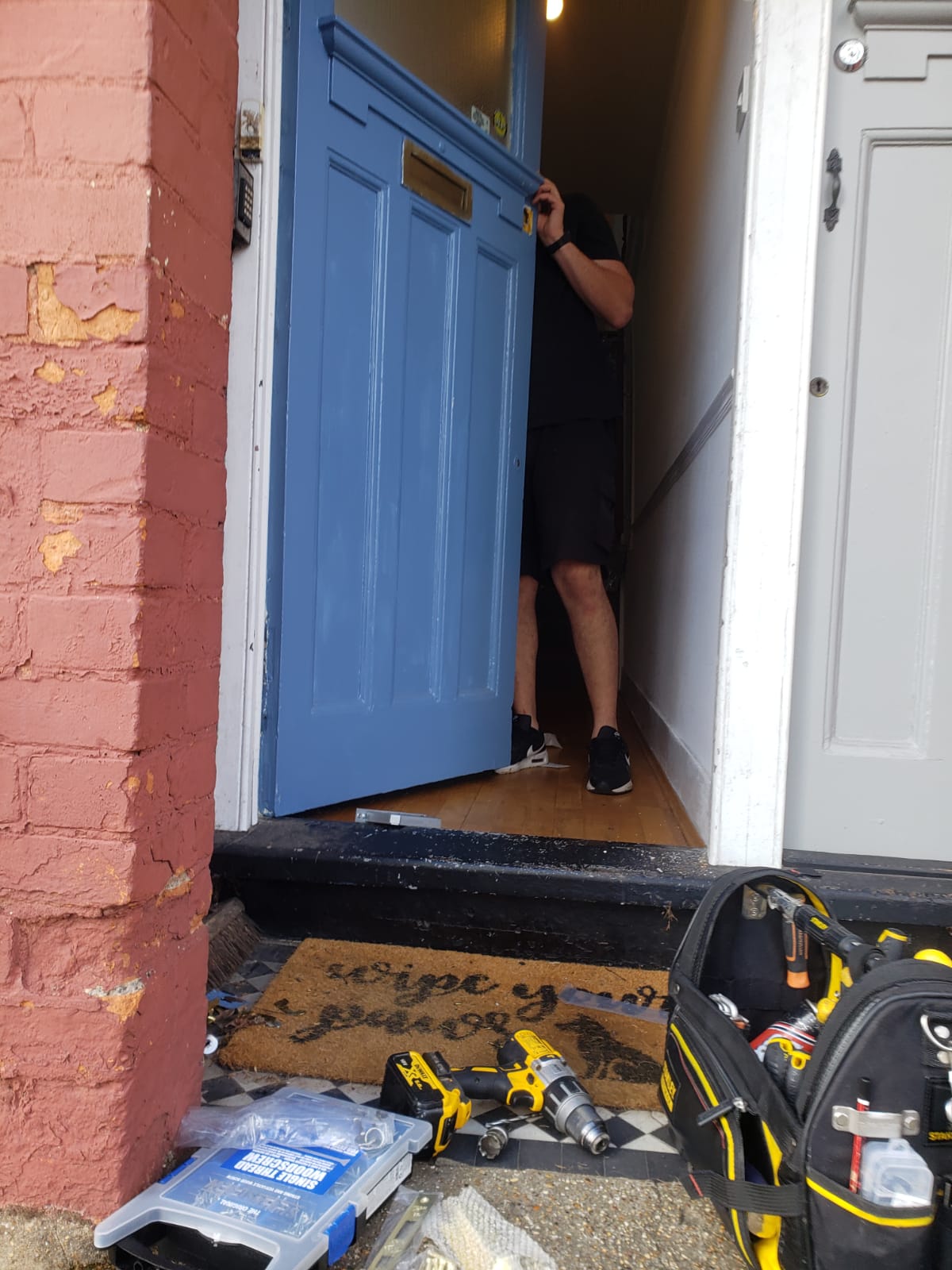 Dan with a blue wooden door